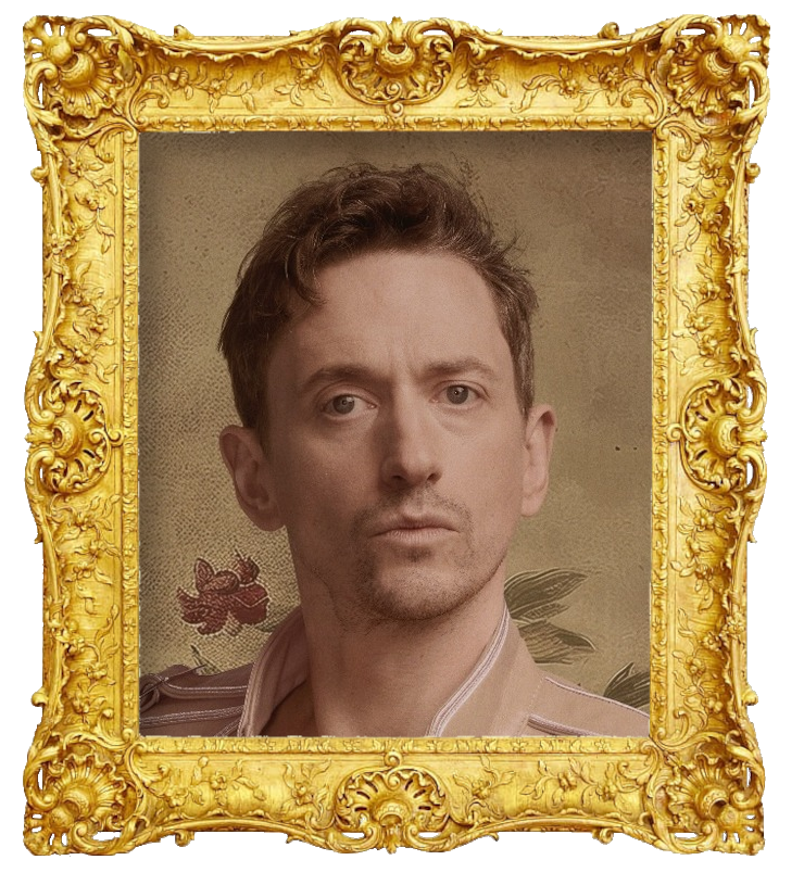 Headshot photo of John Robins surrounded with an ornate golden frame.