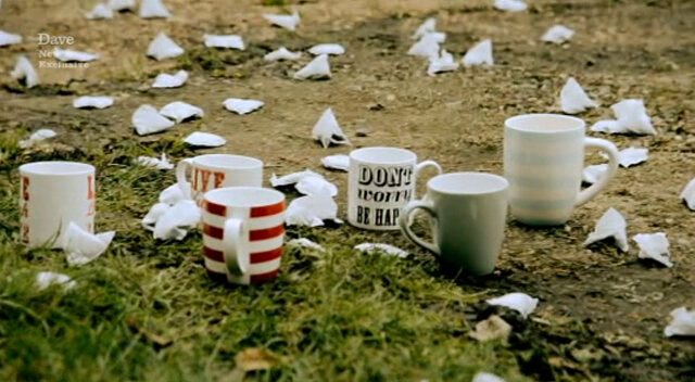 Image of the ground outside the Taskmaster house, scattered with half a dozen mugs and dozens of dry teabags.