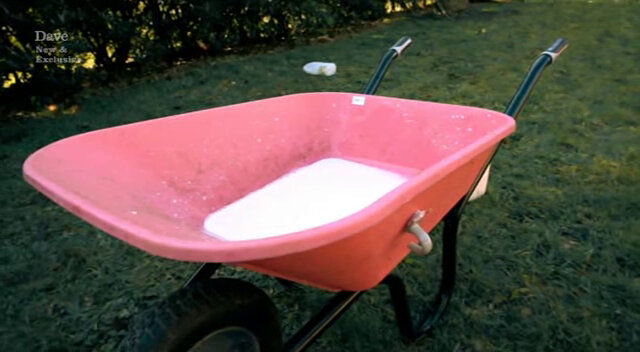 Image of a pink plastic wheelbarrow with a pool of milk in the bottom. Sorry, a ‘mug’.