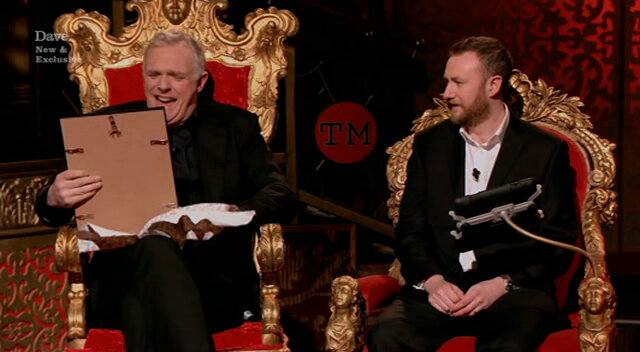 Image of Greg Davies reacting to the portrait that Romesh commissioned of him.