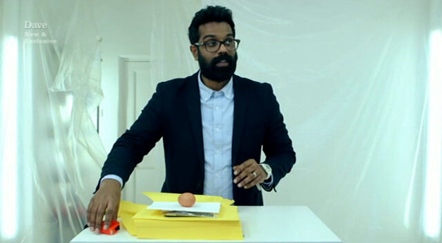 Image of Romesh balancing the egg on top of the pile of supplies with which he was provided.