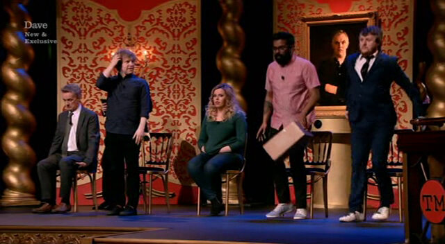 Image of Romesh and Tim standing up at the same time.
