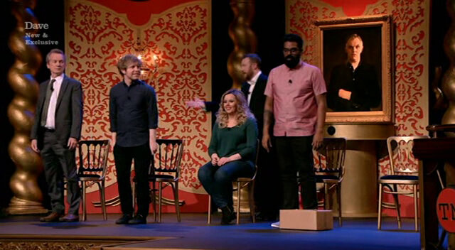 Image of Frank after he joined the other contestants in standing (with Tim Key having retreated from the stage after his attack).