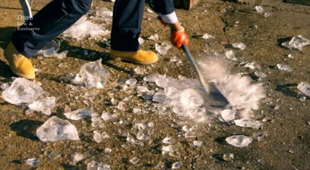 Image of Romesh pulverising the remaining chunks of ice with a garden spade.
