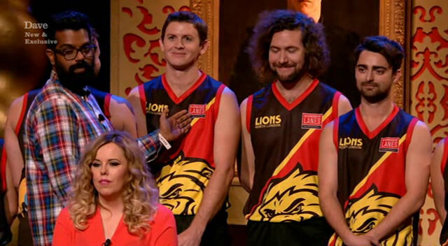 Image of Romesh Ranganathan trying to correctly introduce three members of an Australian Rules Football team.
