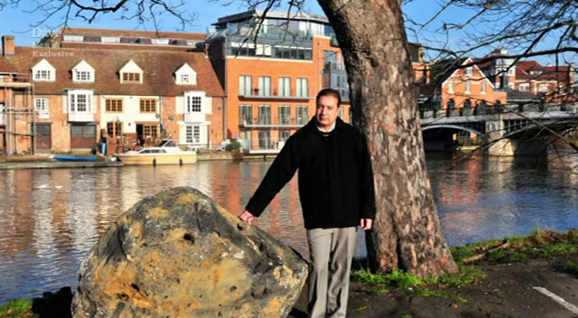 Image of the taxi driver posing next to the boulder on the bank of the River Thames in Windsor.