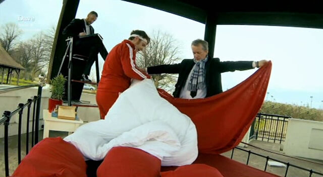 Image showing Frank Skinner and Tim Key trying to make a bed together while holding hands.
