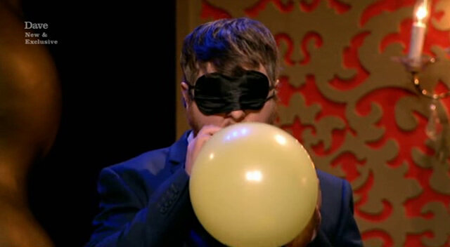 Image of Tim Key inflating his balloon.