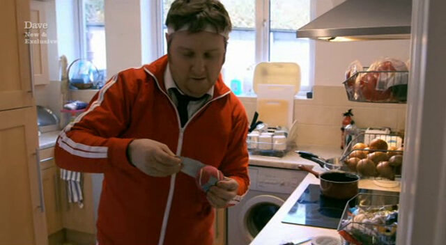 Image showing Tim Key constructing a protective shield around his mini golf egg by securing it inside a pink tennis ball.