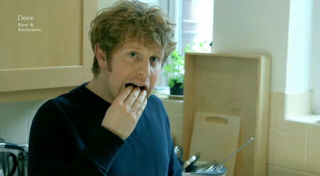 Image showing Josh Widdicombe stuffing one of many ingredients into his mouth during the preparation of his meal.
