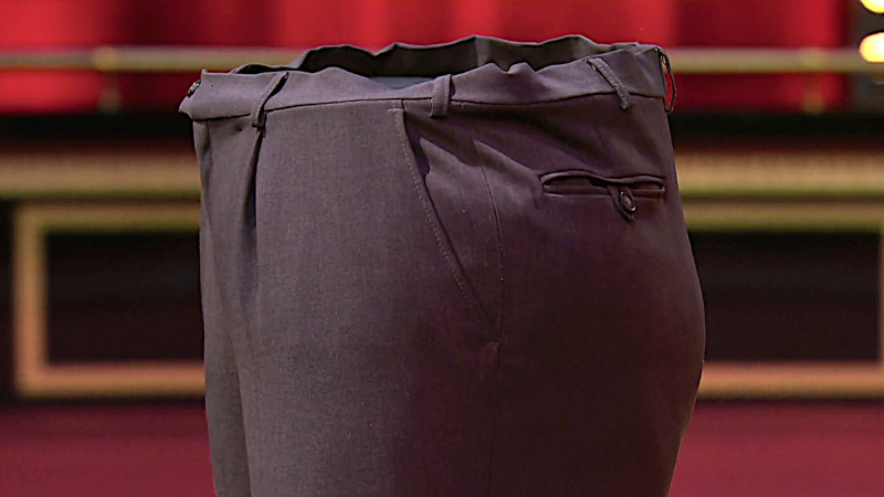 Image of the prize in this episode: a pair of trousers from the first task in the episode, freshly pressed.