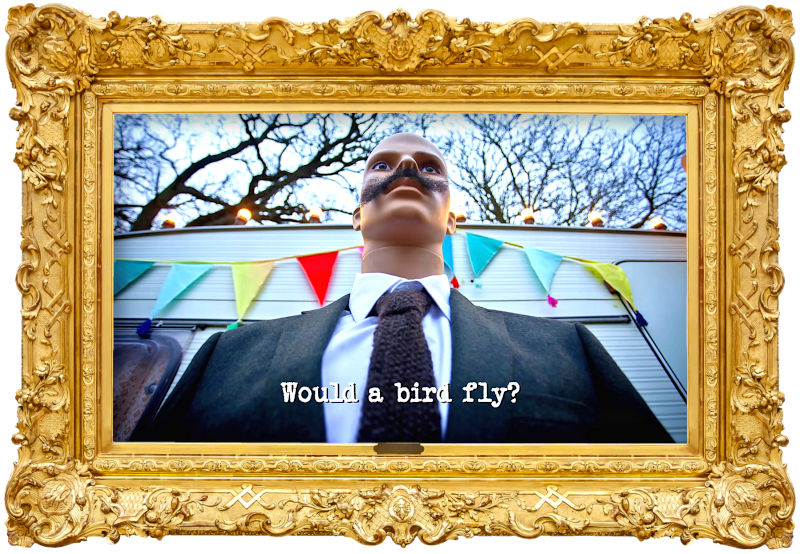 Photo taken from a low angle, looking up at a mannequin with a moustache, wearing a suit, and standing in front of the caravan (referencing the 'Deliver a medium mocha to Mike’s mate Mark' task), with the episode title, 'Would a bird fly?', superimposed on it.