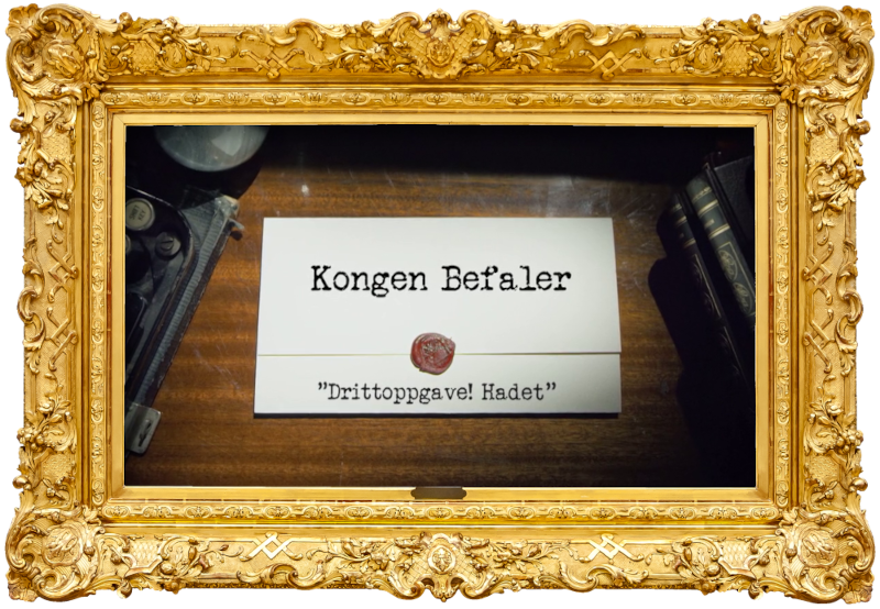 Image of the title card at the start of this episode, showing a task brief with the show title, 'Kongen Befaler', and the episode title, 'Drittoppgave! Hadet' ['Shit task! Goodbye'], on a wooden desk. At the edges of the image, part of a typewriter keyboard and a stack of leather-bound books can be seen.