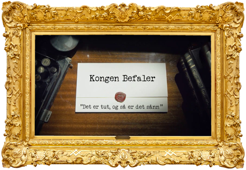 Image of the title card at the start of this episode, showing a task brief with the show title, 'Kongen Befaler', and the episode title, 'Det er tut, og så er det sånn' ['It's a tube, and then it goes like this'], on a wooden desk. At the edges of the image, part of a typewriter keyboard and a stack of leather-bound books can be seen.