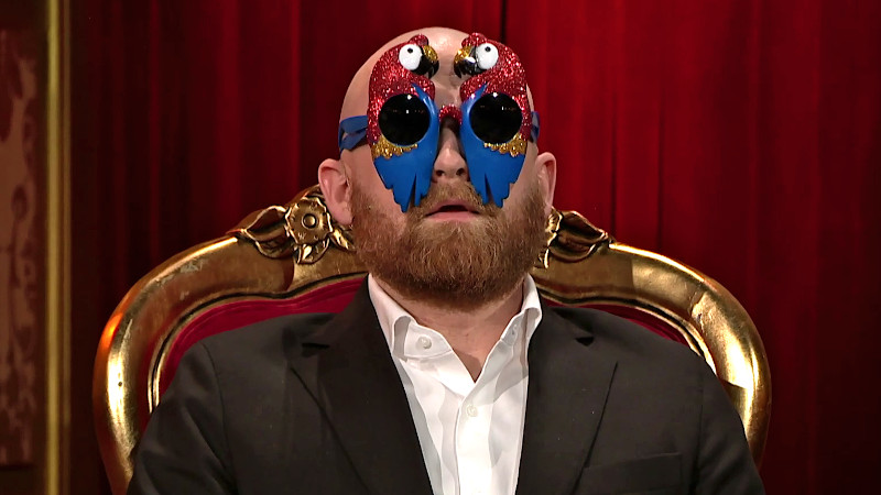 Image of Mark Le Fêvre wearing his “finale sunglasses”, the frames of which are designed to resemble glittery parrots.