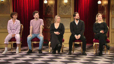 Image of the panel of contestants seated on stage together during this episode.