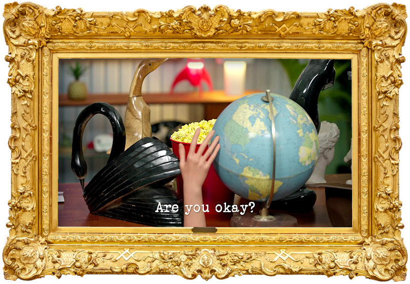 Image of a bucket of popcorn on a desk, surrounded by figurines of birds and cats, a mannequin's hand, and a world globe (a reference to the 'Protect the popcorn' task), with the episode title, 'Are you okay?', superimposed on it.