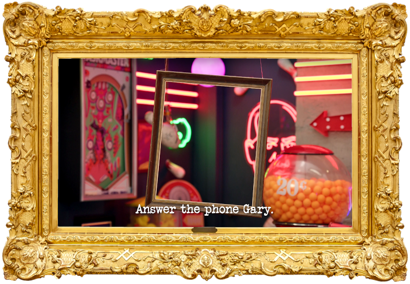 Image of a picture frame hanging from the ceiling of the study (taken during Anne Edmonds' attempt at the 'Write and perform a jingle for a small business' task), with the episode title, 'Answer the phone Gary', superimposed on it.