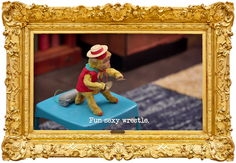 Image of a battery-powered cymbal-playing monkey toy on a stool (a reference to Anne Edmonds' attempt at the 'Apply for your childhood dream job' task), with the episode title, 'Fun sexy wrestle', superimposed on it.