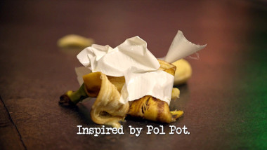 Image of a mangled banana wrapped in white gaffer tape (a reference to Rhys Nicholson's attempt at the 'Make an instructional video for the Taskmaster' task), with the episode title, 'Inspired by Pol Pot', superimposed on it.