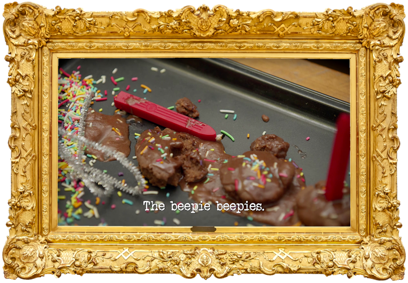 Image of some small chocolate cakes on a baking tray, with hundreds and thousands unevenly sprinkled over them, and small red sealing wax candles instead of normal birthday candles (a reference to Emma Holland's attempt at the 'Celebrate your selected national day' task), with the episode title 'The beepie beepies' superimposed on it.