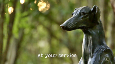 Image of a statue of a dog (it's unclear what in the episode this might be a reference to), with the episode title, 'At your service', superimposed on it.