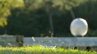 Blurred image of an exercise ball on the pond dock (a reference to the 'Get the Swiss ball into the kayak' task), with the episode title, 'Unbung', superimposed on it.