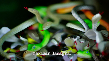 Image of a tangle of toy rubber snakes (a reference to the 'Frighten the Taskmaster' task), with the episode title, 'Mexican lasagna', superimposed on it.