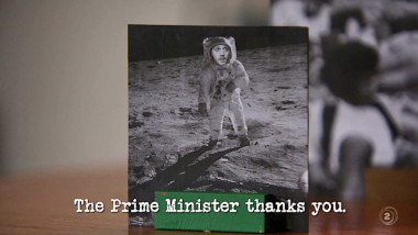 Image of a photo of an astronaut on the moon, with Paul Williams' face crudely photoshopped onto it (a reference to the 'Make history' task), with the episode title, 'The Prime Minister thanks you', superimposed on it.