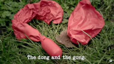 Image of the remnants of a burst red balloon on some grass (taken during the 'Burst all of the balloons' task), with the episode title, 'The dong and the gong', superimposed on it.