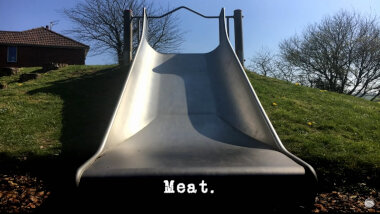 Image of a metal slide in a children's playground (a reference to the 'Slide as far as possible' task), with the episode title, 'Meat', superimposed on it.