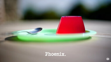 Image of a small red jelly on a green plate, with a spoon (a reference to the 'Eat one item, balance one item, throw one item' task), with the episode title, 'Phoenix', superimposed on it.