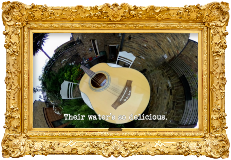 A 360 camera image of an acoustic guitar on a garden table (a reference to the 'Write and perform a song about a stranger' task), with the episode title, 'Their water’s so delicious', superimposed on it.