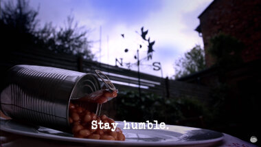 Image of an open can of baked beans, spilling out onto a plate (presumably a reference to Iain Stirling's attempt at the 'Make a realistic injury using food' task), with the episode title, 'Stay humble', superimposed on it.