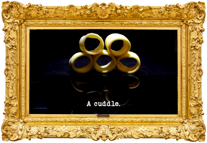 Image of five Hula Hoops potato crisps stacked up in a pyramid (a reference to the 'Find and put the gold rings on the stick' task), with the episode title, 'A cuddle', superimposed on it.