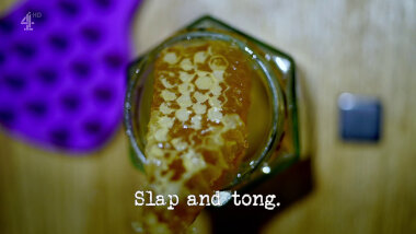 Image of a hexagonal jar containing a piece of real honeycomb (a reference to the 'Make the best uniform for this bee' task), with the episode title, 'Slap and tong', superimposed on it.