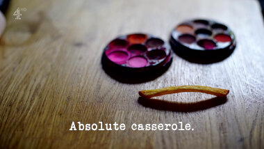 Image of a single French fry and two small sets of watercolour paint (presumably a combined reference to the 'Make a portrait of the Taskmaster on a door using your feet' and 'Identify the battered items' tasks), with the episode title, 'Absolute casserole', superimposed on it.