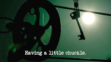 Silhouetted image of a key attached to a pulley washing line (a reference to the 'Make a key difficult to retrieve' task), with the episode title, 'Having a little chuckle', superimposed on it.