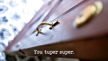 Image of the handle of the front door of the Taskmaster house (a reference to the 'Walk through the door wearing the longest shoes and biggest hat' task), with the episode title, 'You tuper super', superimposed on it.