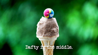 Image of an ice cream cone dusted with sand, with a bouncy ball on top (a three-way combined reference to the 'Put the most sand in the shopping trolley' task, the 'Identify the ice cream flavours' task, and the 'Catch something' task), with the episode title, 'Dafty in the middle', superimposed on it.