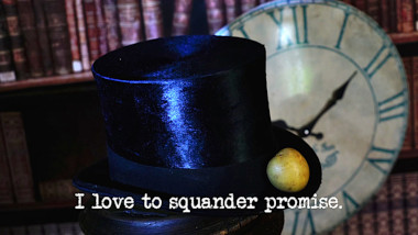 Photo of a small potato laid on the brim of a top hat, in front of a clockface (a reference to both the 'Exit the caravan after exactly 20 minutes' and 'Catch the potatoes in the potato hat' tasks), with the episode title, 'I love to squander promise', superimposed on it.