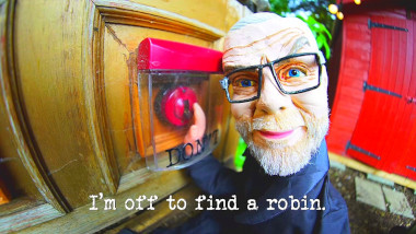 Photo of a wooden puppet of Greg Davies about to flick a Bakelite switch with a safety cover over it (a reference to the 'Play with these switches / Balance the most golf tees' task), with the episode title, 'I'm off to find a robin', superimposed on it.