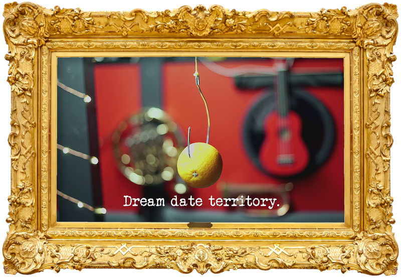 Photo of an orange impaled on a large hook, with musical instruments in the blurred background (referencing the 'Get the most orange juice in the vase', 'Figure out what you’ve caught', and 'Perform a recognisable piece of classical music' tasks), with the episode title, 'Dream date territory', superimposed on it.