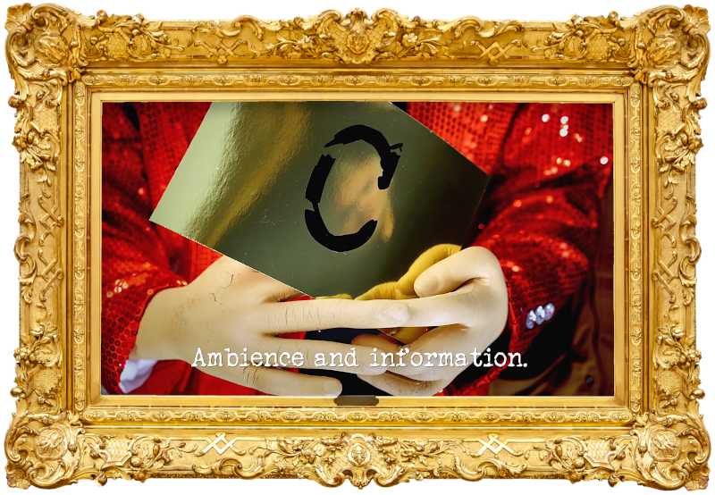 Photo of the hands of a mannequin wearing a glitzy red jacket, and holding a gold card with the letter 'C' printed on it (referencing the 'Hug your special friend' and 'Create a shiny floor American game show' tasks), with the episode title, 'Ambience and information', superimposed on it.