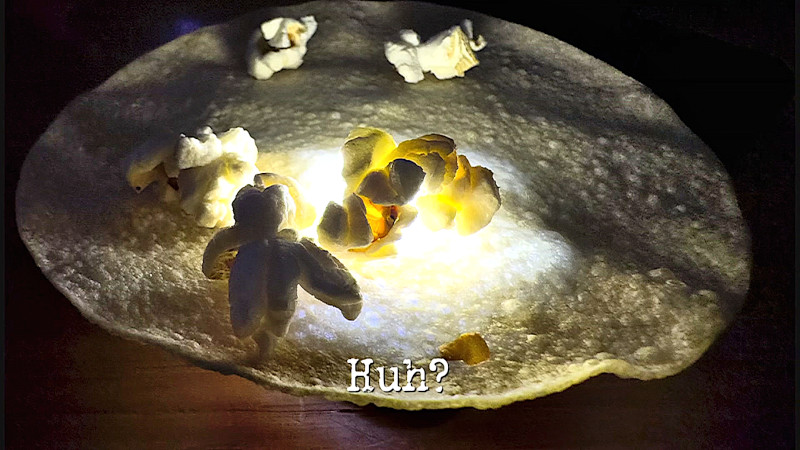 Photo of some pieces of popcorn on top of a poppadom (a reference to the 'Eat the poppadoms while complimenting Greg or insulting Alex' and 'Make everything pop at the same time' tasks), with the episode title, 'Huh?', superimposed on it.