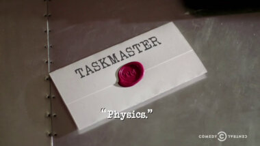 Image of a task brief laid on a metallic surface, with the episode title, 'Physics', superimposed on it.