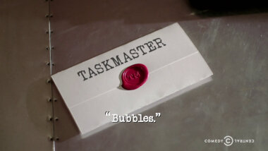 Image of a task brief laid on a metallic surface, with the episode title, 'Bubbles', superimposed on it.