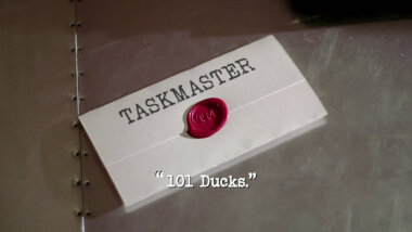 Image of a task brief laid on a metallic surface, with the episode title, '101 Ducks', superimposed on it.