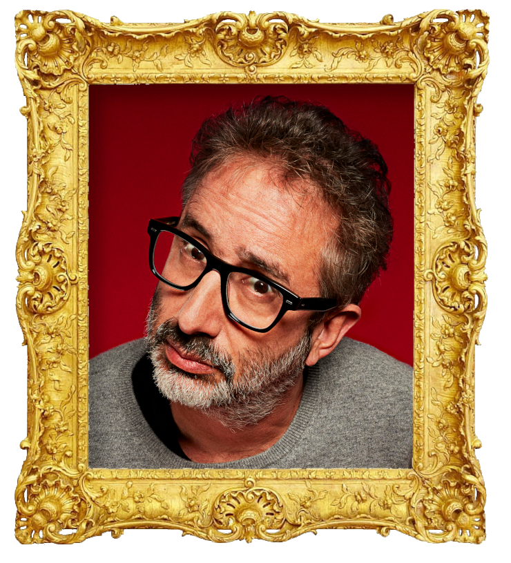 Headshot photo of David Baddiel surrounded with an ornate golden frame.