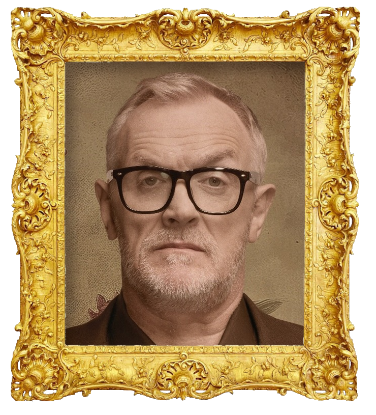 Headshot photo of Greg Davies surrounded with an ornate golden frame.
